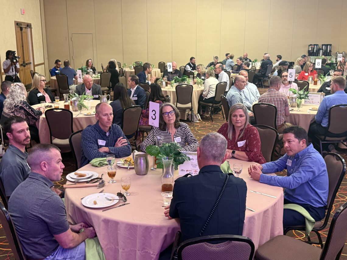 Quarterly Membership Luncheon Attendees talking to chief of police.