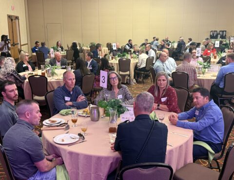 Quarterly Membership Luncheon Attendees talking to chief of police.
