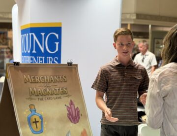 YEA! Student Speaks to Community Member at Trade Show
