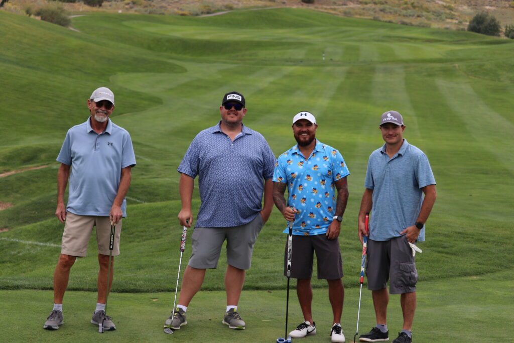 Golf participants pose on the green for the Grand Junction Area Chamber Golf Tournament in 2025