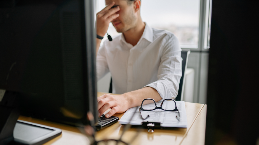 Worker expresses stress at this desk